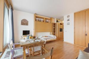 a kitchen and dining room with a table and chairs at Studio Sansi 34 - Happy Rentals in Cesana Torinese +16 photos
