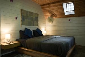 a bedroom with a bed in a wooden room at The Door to Nirvana Backpackers Hostel Kotagiri in Kotagiri