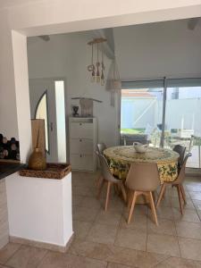 a kitchen and dining room with a table and chairs at Maison individuelle piscine extérieure in Port-Saint-Louis-du-Rhône