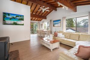a living room with a couch and a table at Drifters @ Callala Beach in Callala Beach