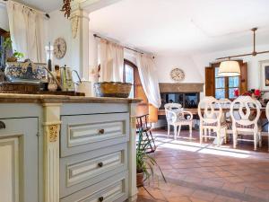 a kitchen with a counter and a dining room at Villa With Pool, Gym, Pond And Panoramic Views in Laterina