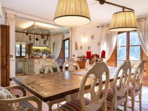 a kitchen and dining room with a wooden table and chairs at Villa With Pool, Gym, Pond And Panoramic Views in Laterina