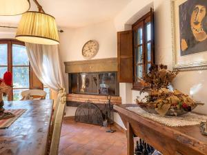 a living room with a table and a fireplace at Villa With Pool, Gym, Pond And Panoramic Views in Laterina +26 photos