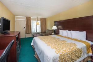 a hotel room with a bed and a flat screen tv at Days Inn by Wyndham Paducah I-24 Exit 4 in Paducah
