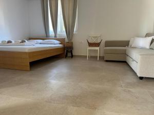 a living room with a bed and a couch at Apartment daal Seline in Seline