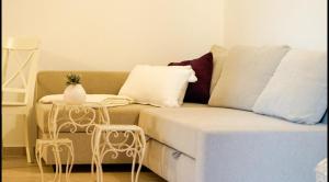 a living room with a couch and two tables at Apartment daal Seline in Seline