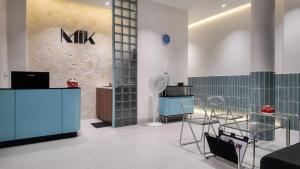 a lobby with a counter with chairs and a table at Mik Stay 2 in Danang