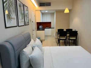 a bedroom with a bed and a dining room at Centrestage PJ by Master House in Petaling Jaya