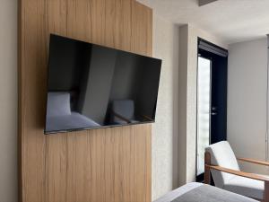 a flat screen tv on a wall in a bedroom at hotel bolam kyoto in Shimo-dachiyuuridōri