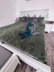 a bed with two stuffed swans on it at Korona Apartman Székesfehérvár in Székesfehérvár