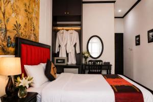 a bedroom with a white bed and a mirror at Hanoi Sena Hotel & Travel in Hanoi +29 photos