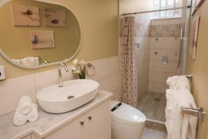 a bathroom with a sink and a shower at Serene Mountain View Smart Apt for Restful Stays in Castries +48 photos