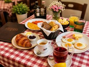 a table topped with plates of breakfast foods and coffee at Casa Matteotti in Rovinj +28 photos