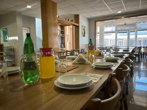 a long wooden table with plates and bottles on it at Maća i Ante Pavlović in Međugorje