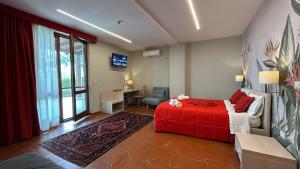 a bedroom with a red bed and a desk at Villa Zufrò in Vibo Valentia