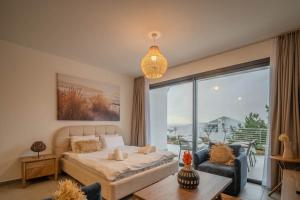 a bedroom with a bed and a large window at Sun Valley Resort & Residency in Kyrenia +288 photos