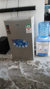 a refrigerator with stickers on it next to a water tower at Crystal Zuri Homes, Kasarani in Nairobi