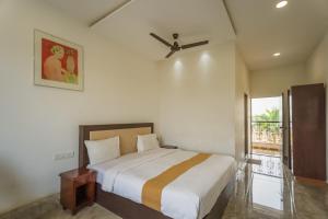 a bedroom with a bed and a ceiling fan at Vasant Vihar Resort in Kevadia