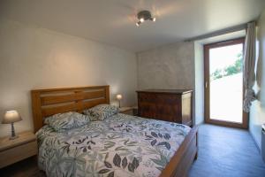 a bedroom with a bed and a window at L'évasion authentique du Vercors in Saint-André-en-Royans
