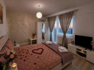 a bedroom with a bed with a heart on it at CENTRAL Apartment 84- free parking- spital Recuperare in Iaşi