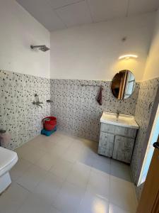 a bathroom with a sink and a mirror at Hotel Namgyal Villa in Nubra +56 photos