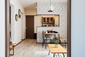 a kitchen and dining room with a table and chairs at Value residence Kugai 3A in Miyako-jima