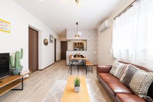 a living room with a couch and a table at Value residence Kugai 3A in Miyako-jima