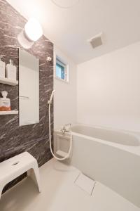 a bathroom with a sink and a bath tub at Value residence Kugai 3A in Miyako-jima +42 photos