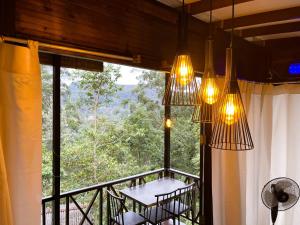 a room with a balcony with a large window at The Mist in Ella