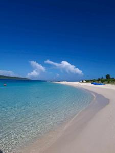 a beach with the ocean and a blue sky at Value residence Kugai 3A in Miyako-jima