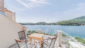 a balcony with a table and chairs overlooking a lake at Villa Matej by Villas Guide in Zaton