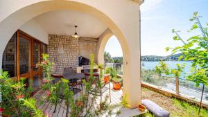 a house with a balcony with a view of the water at Villa Matej by Villas Guide in Zaton