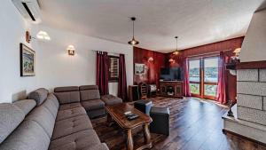 a living room with a couch and a table at Villa Matej by Villas Guide in Zaton +27 photos