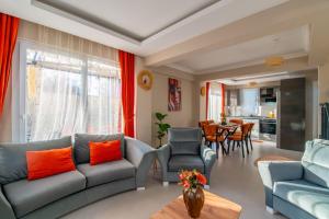a living room with two couches and a table at Sureyya Hotel By Kalipso in Oludeniz