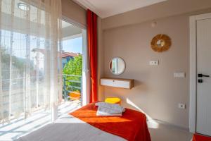 a bedroom with a bed and a large window at Sureyya Hotel By Kalipso in Oludeniz +54 photos