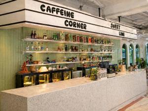 a counter in a store with a lot of bottles at Bangkok Group Bunk Hotel Khaosan in Bangkok