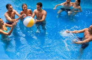 a group of people playing with a beach ball in the water at Bangkok Group Bunk Hotel Khaosan in Bangkok