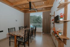 a dining room with a table and chairs at River Side Paradise By Greenleaves Munnar in Anachal