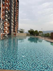 a large swimming pool in front of a building at Sufi Idaman Homestay for Islamic only in Nilai