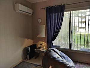 a living room with a couch and a window at Madinaty Summer cottage in Cairo
