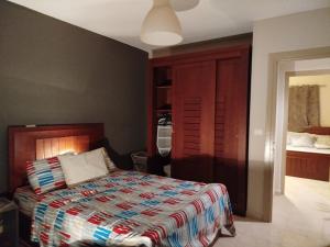 a bedroom with a bed with a colorful comforter at Madinaty Summer cottage in Cairo +8 photos