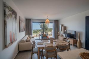 a living room with a table and chairs at Sun Valley Resort & Residency in Kyrenia