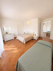 a bedroom with two beds in a room at APPARTAMENTI LA CONCHIGLIA in Caorle