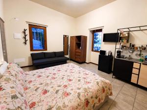 a bedroom with a bed and a couch in it at BaB Apartments Tavernola in Tavernola Bergamasca