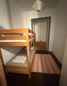 a small room with a bunk bed and a doorway at Summer Haze Ericeira in Ericeira