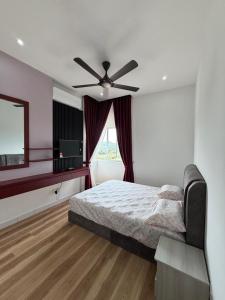 a bedroom with a bed and a ceiling fan at Sufi Idaman Homestay for Islamic only in Nilai +11 photos