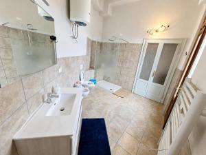a bathroom with a white sink and a toilet at BaB Apartments Tavernola in Tavernola Bergamasca +44 photos