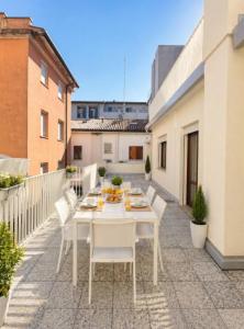 a white table and white chairs on a balcony at APPARTAMENTI LA CONCHIGLIA in Caorle