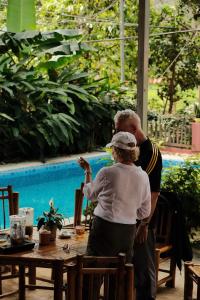 a man and a woman standing in front of a table at NorthWest Home in Mai Châu