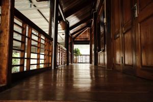 an empty hallway in a building with wooden walls at NorthWest Home in Mai Châu